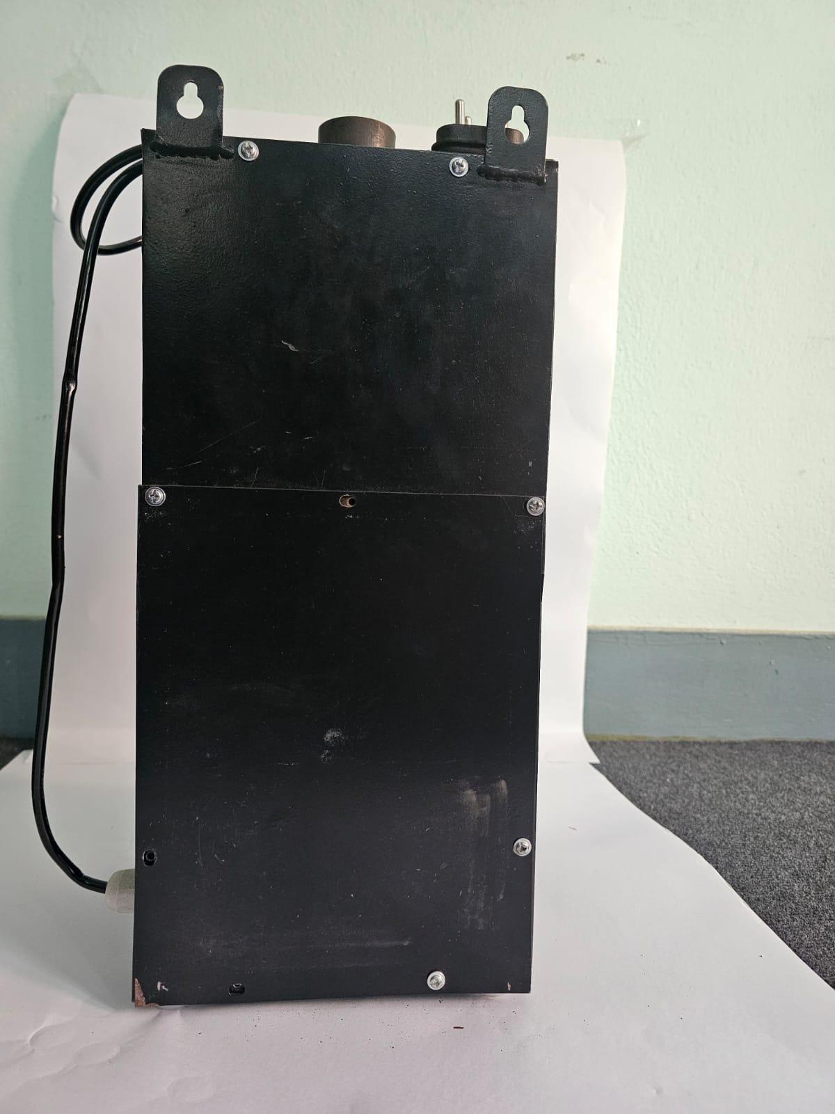 Rear view of a black wall-mounted sanitary pad incinerator displaying heavy-duty metal hanging brackets and power cable routing.