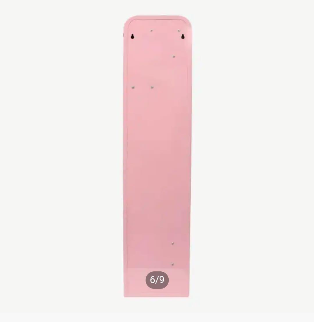 Smooth rear metal panel of a tall pink vending machine featuring top mounting holes for wall installation.