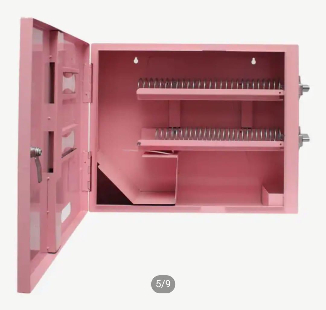 Open cabinet view showing internal dual spiral delivery coils and storage compartment of a manual vending machine.