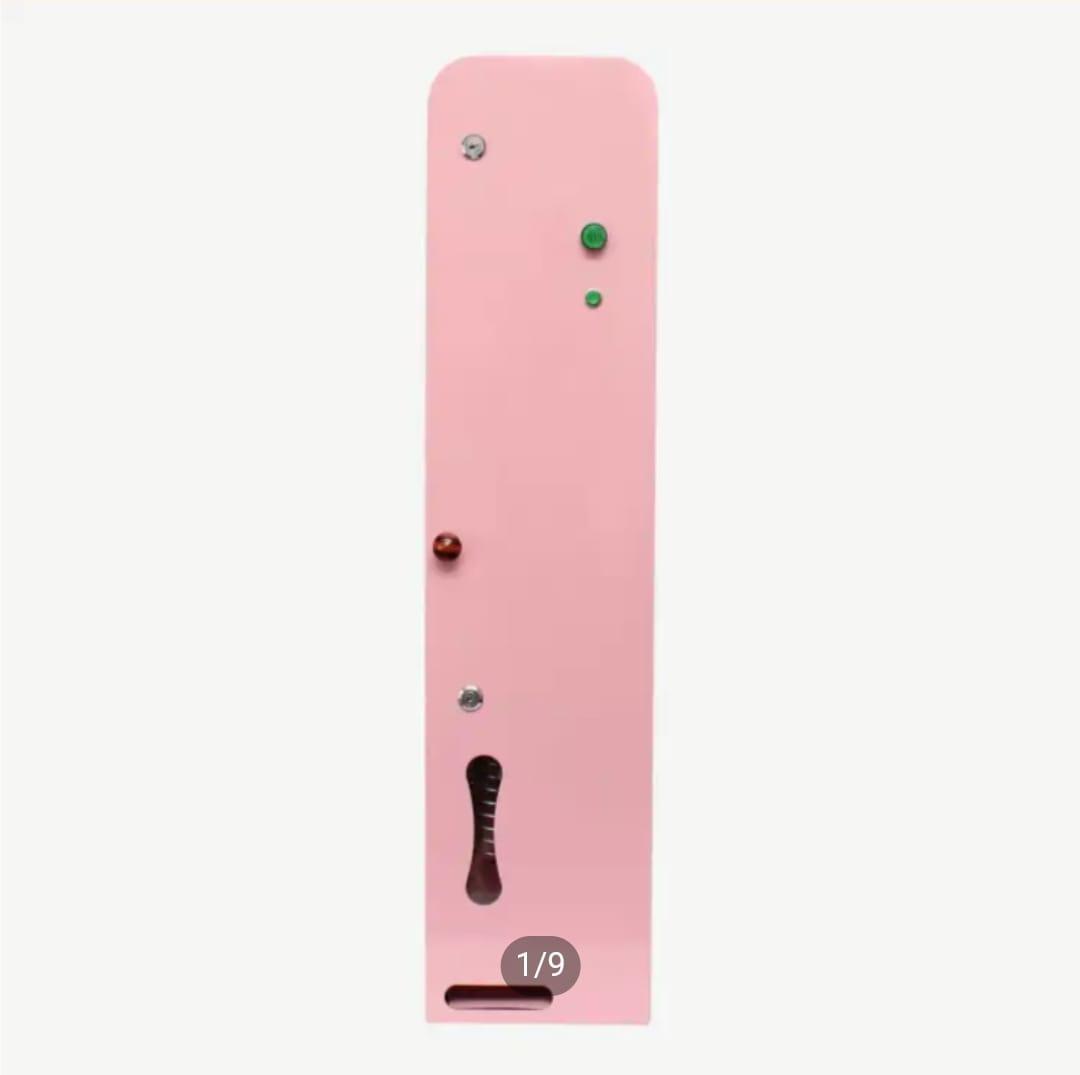 Front view of a slim, wall-mounted pink automated vending machine showing status indicator lights and dispensing slot.